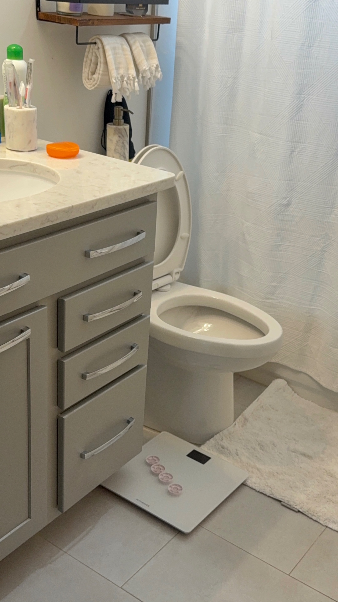 Bathroom cabinet, tile floor and toilet
