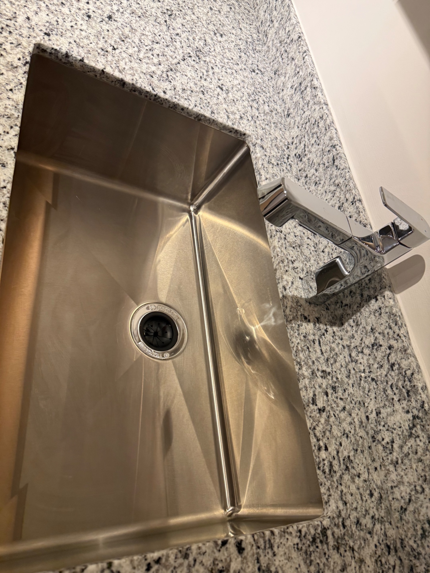 Clean stainless steel kitchen sink and countertop